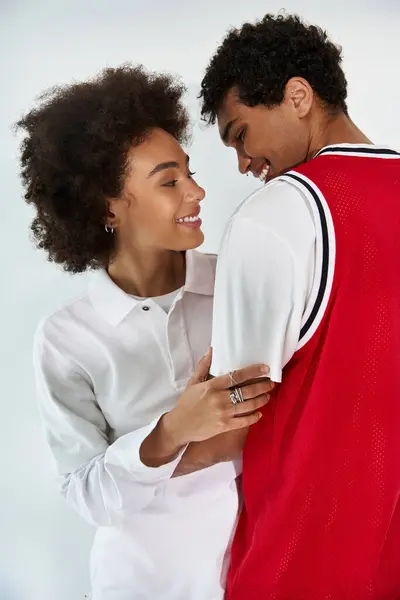 Joyful young couple embraces each other, radiating love and connection in a chic atmosphere. — Stock Photo