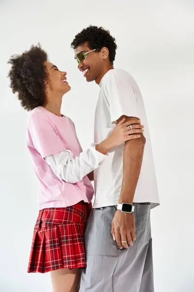 A young couple shares a playful and intimate moment, enjoying each others company with smiles. — Stock Photo