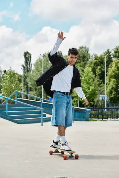 Skater glides confidently on a board, showcasing skill and balance under a bright sky. — Stock Photo