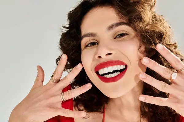 A young woman beams in stylish summer wear, showcasing her accessories with a bright smile. — стокове фото