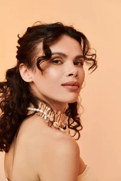 A beautiful young woman poses gracefully, showcasing her unique summer fashion and radiant glow. — Stock Photo