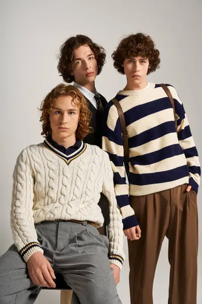 Young men showcase their style and friendship through fashion in a studio setting. — Stock Photo