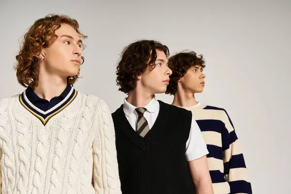 Three fashionable men pose confidently in a chic studio, displaying their unique styles together. — Stock Photo