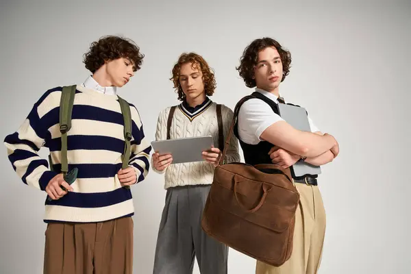 Three fashionable young men express their personal style while posing together with accessories. — Stock Photo