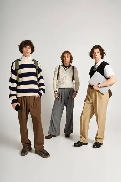Three young men express their fashion sense and camaraderie with unique clothing styles and poses. — Stock Photo