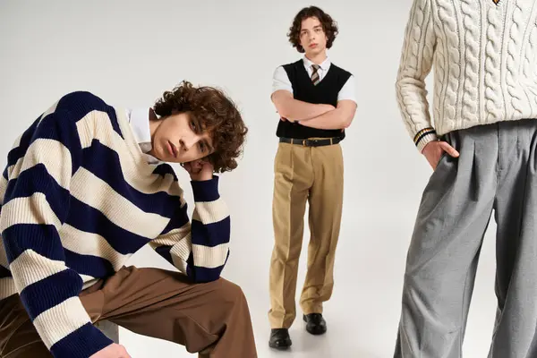 Three young men express their unique styles while posing together in fashionable outfits — Stock Photo