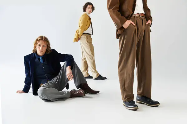 Three stylish young men exude friendship and confidence in a modern setting. — стоковое фото