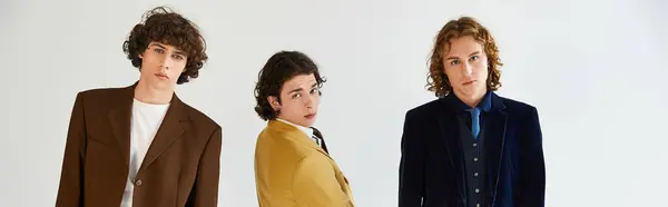 Stylish young men pose together sharing smiles and showcasing their unique fashion sense. — Stock Photo