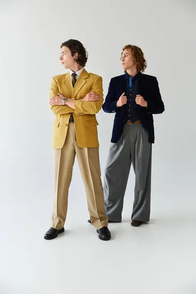 Two young men confidently pose together, highlighting their unique fashion choices and friendship. — Stock Photo