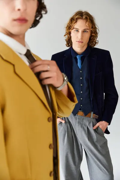 Two fashionable young men pose confidently, highlighting their unique styles in casual elegance. — Stock Photo