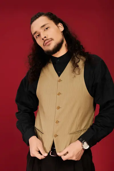 A young man with a beard showcases his charm in a stylish vest, exuding confidence and charisma. — Stock Photo