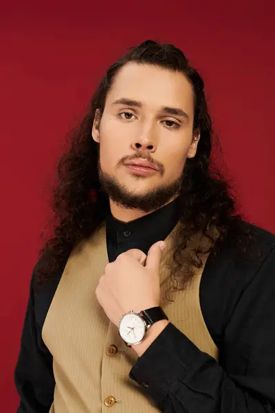 A young man with a beard presents a captivating expression while dressed elegantly, radiating charm. — Stock Photo