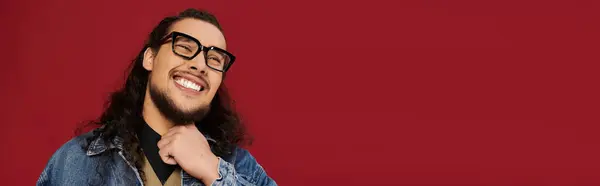 Charming young man poses with a smile, showcasing a well groomed beard and stylish glasses. — Stock Photo