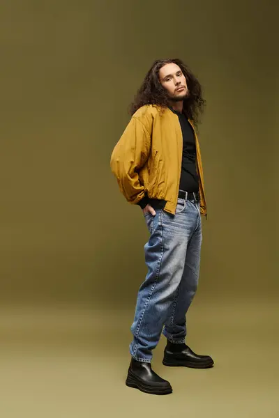 Confident young man with a beard flaunts his style against a minimalist backdrop. — Stock Photo