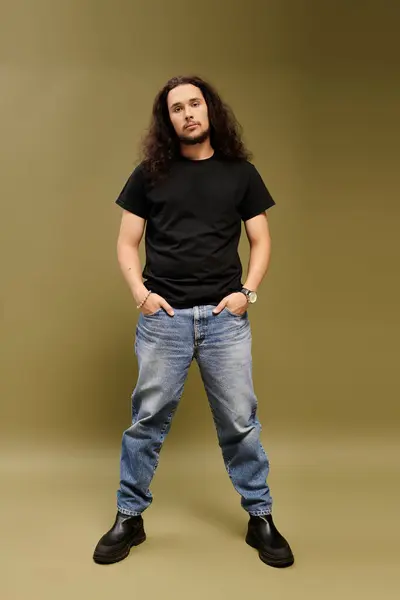 A young bearded man exudes charm while casually posing in trendy clothing with a confident air. — Stock Photo