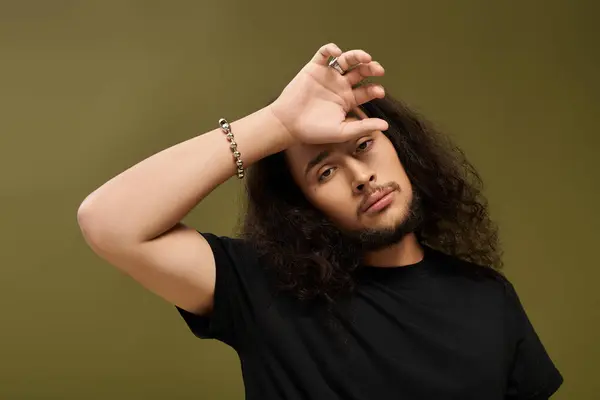 A handsome young man with a beard strikes a confident pose, showcasing his style and charm. — Stock Photo