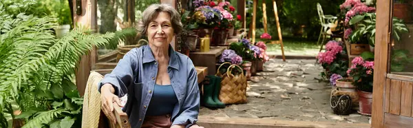Senior woman relishing a peaceful moment in her vibrant, diverse flower garden. — Stock Photo
