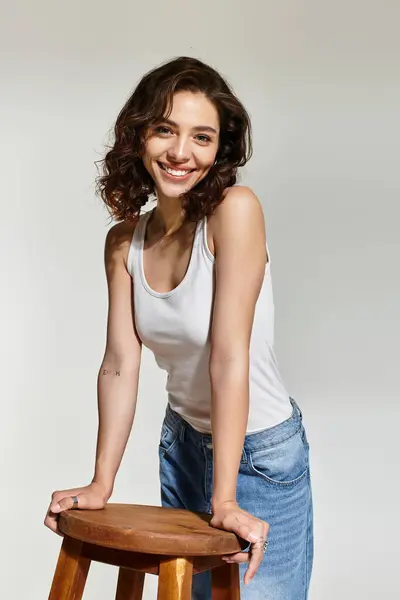A young woman with beautiful makeup and brown hair poses playfully at a studio. — Stock Photo
