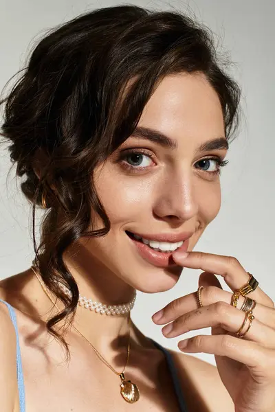 Beautiful woman poses playfully in a modern studio, highlighting her artistic makeup and charm. — Stock Photo