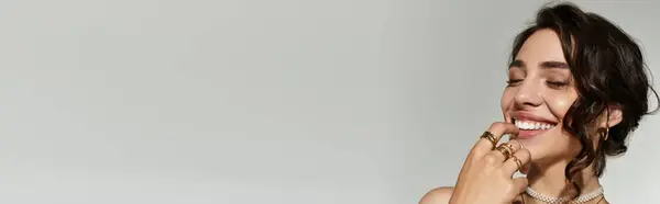 A young woman with stunning makeup smiles, radiating charm and confidence, banner — Stock Photo