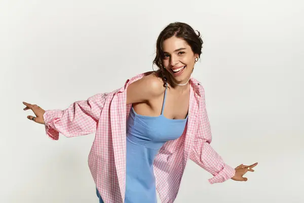 Young woman in a blue dress smiles happily in a studio setting, enjoying her summer look. — Stock Photo