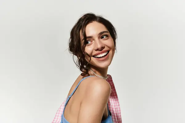 A young woman beams with joy, showcasing her summer style in a blue dress and lovely makeup. — Stock Photo