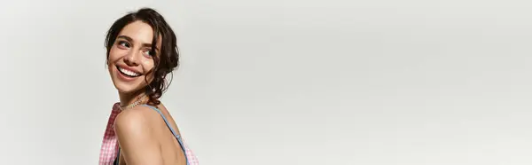 Young woman with pretty makeup and brown hair smiles joyfully while modeling, banner — Stock Photo