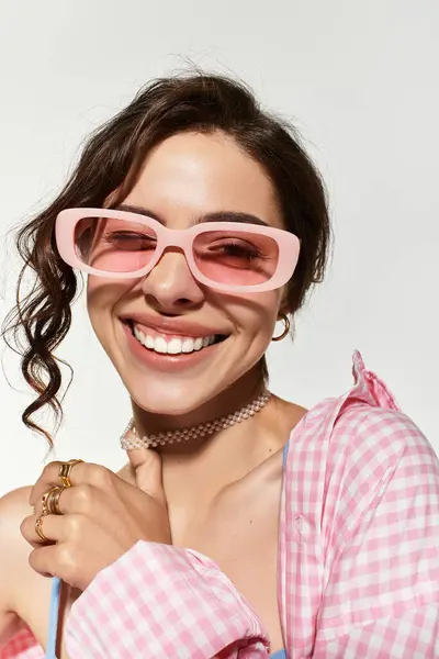 Young woman beams with joy, showcasing her fashion sense in a studio environment. — Stock Photo