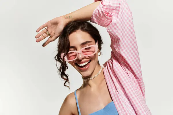 A young woman with pretty makeup joyfully poses in a blue dress while enjoying the moment. — Stock Photo