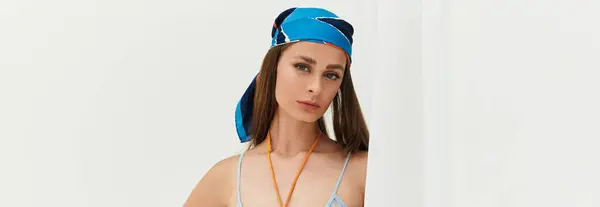 A young beautiful woman stands outdoors, radiating summer vibes in a stylish outfit with a scarf. — Stock Photo