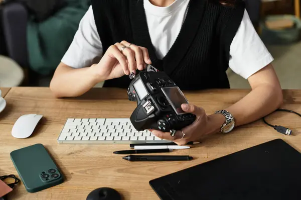 A talented young woman is focused on her camera while working from the comfort of her home. — Stock Photo