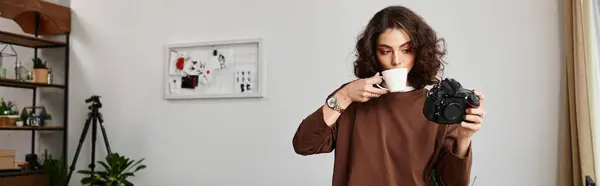 Freelancer with curly hair enjoys coffee and takes pictures in her cozy home workspace, banner — Stock Photo