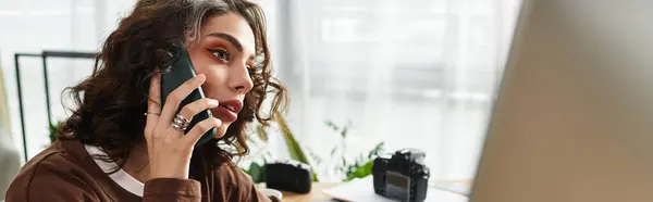 A freelancer is talking on the phone while focused on her work in a stylish home office space, banner — Stock Photo