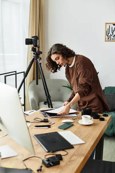 Curly-haired freelancer engages in creative photography while working from her stylish home office. — Stock Photo