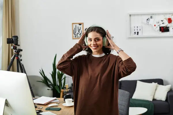 Young woman with curly hair smiles as she engages in her work from home environment with passion. — Stock Photo