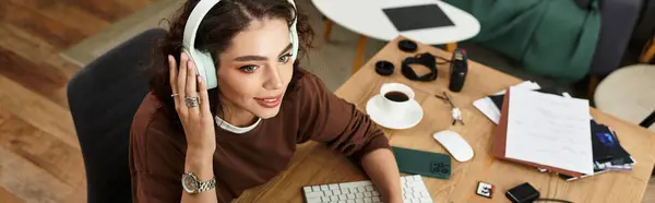 Young woman with curly hair is engaged in remote work, surrounded by a vibrant home office setup, banner — Stock Photo