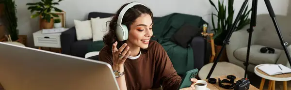 A young woman with curly hair is engaged in remote work at home, banner — Stock Photo