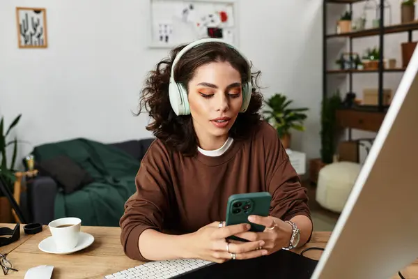 Young woman with curly hair focused on editing while comfortably working from home. — Stock Photo
