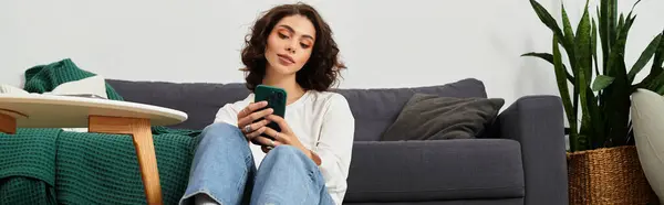 Young woman with curly brown hair enjoys a moment of relaxation in her stylish apartment, banner — Stock Photo