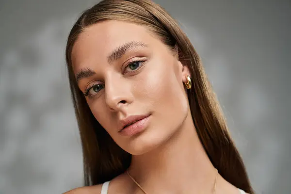 A young woman showcases her natural makeup and radiant skin while enjoying a summer vibe indoors. — Stock Photo
