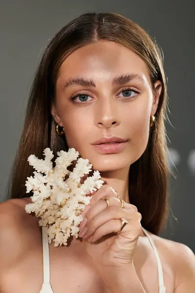 A young woman with tan skin and natural makeup radiates beauty in a summer studio setting. — Stock Photo