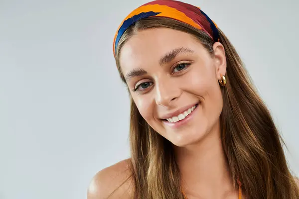 Bright studio setting showcases a young woman radiating beauty in summer attire. — Stock Photo