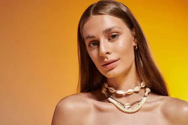 Young woman poses elegantly in a summer outfit, adorned with a seashell necklace, radiating warmth. — Stock Photo