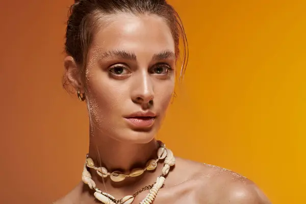 A young woman showcases her summer outfit and natural beauty in a vibrant studio. — Stock Photo