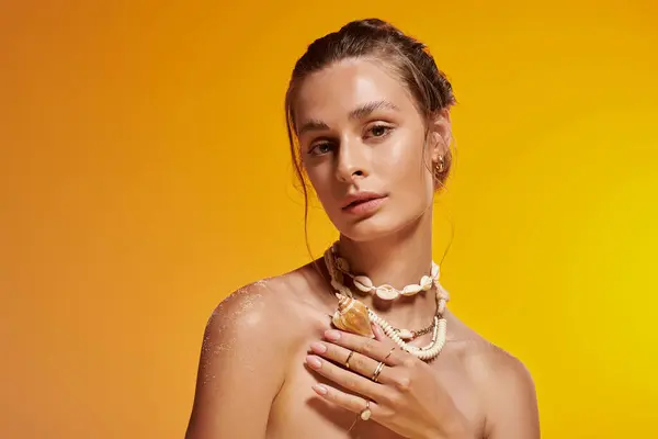 A confident young woman in a summer outfit and seashell necklace radiates natural beauty. — Stock Photo