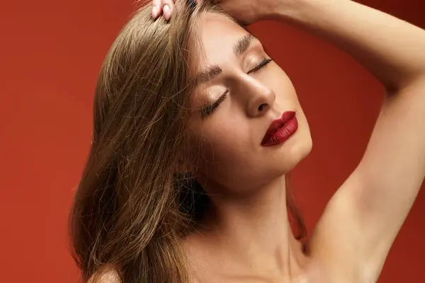 A young beautiful woman poses gracefully with her eyes closed, showcasing her elegant features. — Stock Photo