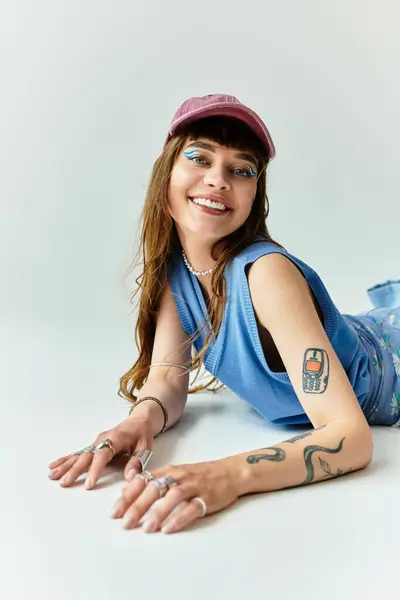 Una giovane donna elegante sorride brillantemente, mostrando il suo stile unico in una posa giocosa. — Foto stock