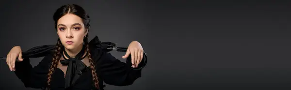 A girl styled with braids wears a Wednesday costume for Halloween, banner — Stock Photo