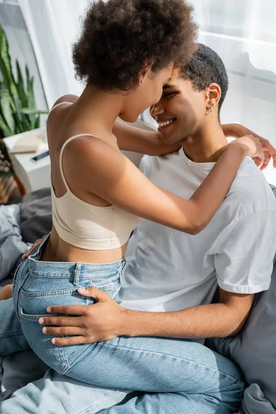 非洲裔美国女人 穿着牛仔裤 接近男友 抱着臀部躺在床上 — 图库照片