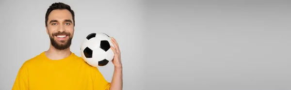Cheerful Bearded Man Yellow Shirt Holding Soccer Ball Isolated Grey — Stock Photo, Image